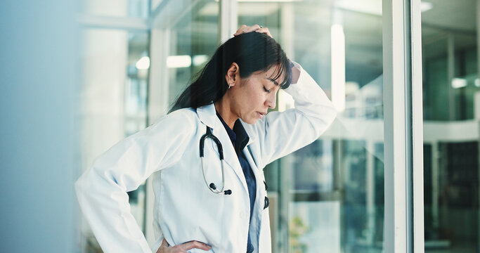Doctor, regret and woman in hospital, think and sad for operation failure, mistake or mental health. Clinic, reflection and mature person with depression for loss, surgery and guilt for medical error