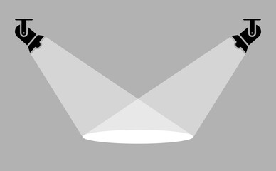 Two spotlights casting intersecting beams on stage