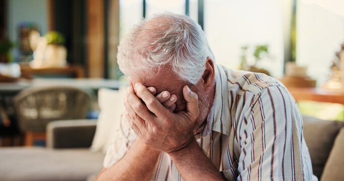 House, sad and old man on couch, crying and grief with mental health, emotional and loss. Pensioner, apartment and senior person with depression, tears and bad news with memory, lonely and mourning