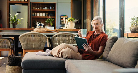 Woman, home and relax with tablet, coffee and watching videos on social media app and...