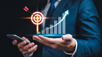 Businessman holding smartphone with rising graph and target with arrow icon business growth