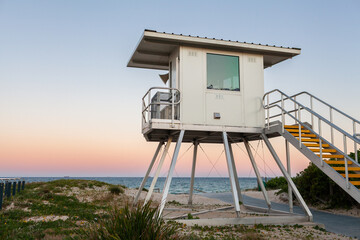 Surf life saving hut lookout building overlooking beach in Australia at dusk  