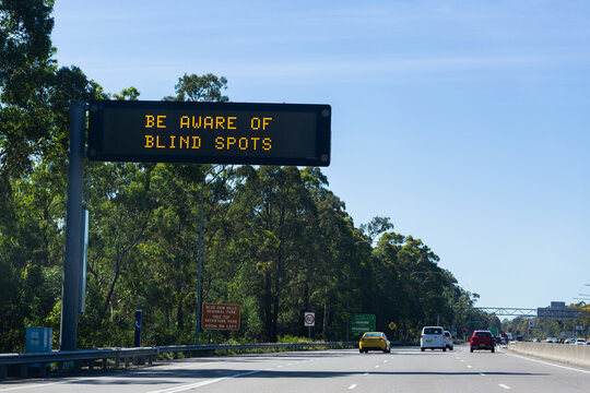 be aware of blind spots warning on digital signage above highway road
