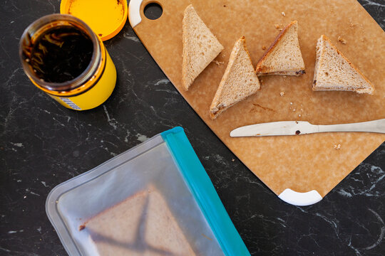 Vegemite sandwich packed for lunch inside reusable food pocket bag on kitchen bench