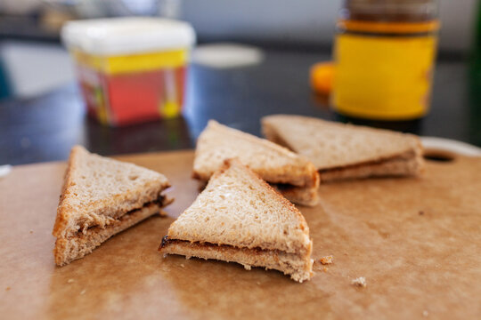 Vegemite sandwich triangles on cutting board on kitchen bench in Australia ready for morning tea