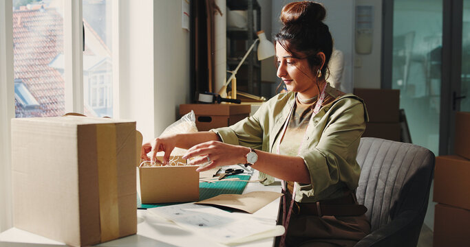 Woman, packing and box at startup ecommerce for order, prepare shipping and customer details. Female person, sorting and package delivery with cardboard inspection, quality assurance for distribution