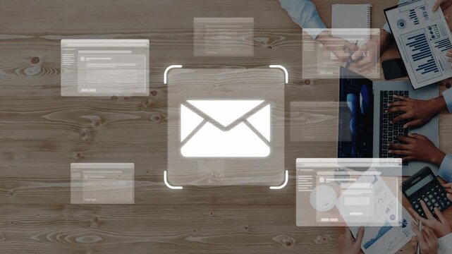 A modern workspace showcasing digital communication through an email icon surrounded by forms and hands actively engaging with devices for effective collaboration. Raster