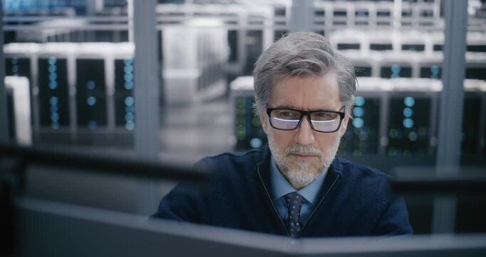 Close Up of Focused, Male Manager Carefully Monitoring Data Systems. Controlling Critical Cloud Infrastructure. Concept Critical Decision Making and High Professional Responsibility. Portrait.