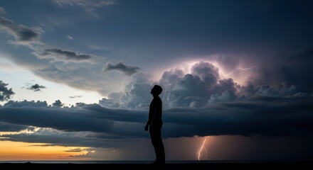 Solitary silhouette observes dramatic thunderstorm lightning over the horizon at dusk