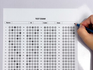 Student hand holding pencil filling out multiple choice answer sheet.1