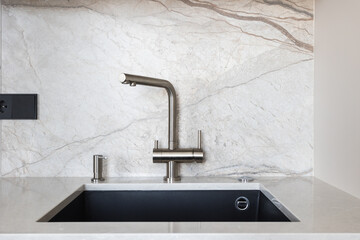 kitchen faucet on a stylish metal sink