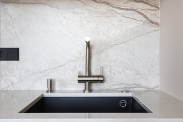 kitchen faucet on a stylish metal sink