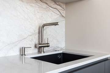 kitchen faucet on a stylish metal sink