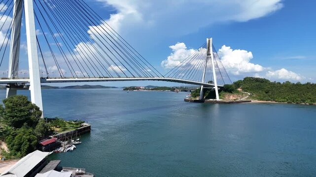 B roll of the Barelang Bridge in Batam showcasing its iconic cable bridge structure spanning blue waters with scenic island views and smooth urban connection