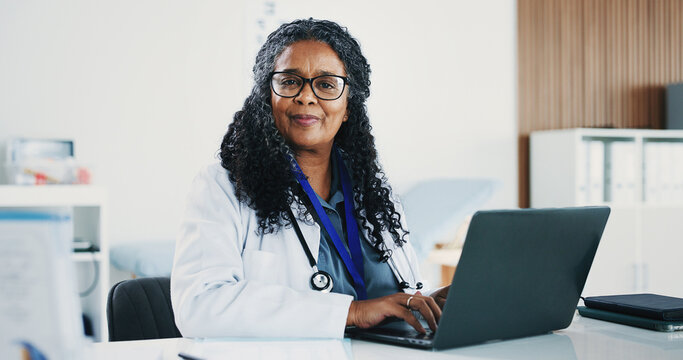 Mature, black woman and portrait of doctor with laptop for medical, healthcare or admin in office. Cardiologist, professional person and tech with clinic schedule, telehealth or research for service