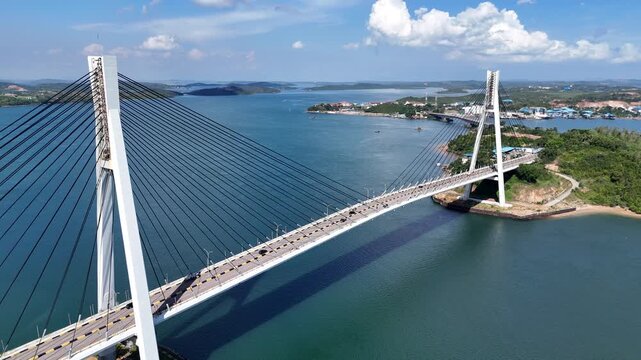 B roll of the Barelang Bridge in Batam showcasing its iconic cable bridge structure spanning blue waters with scenic island views and smooth urban connection