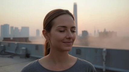 Young woman smiling peacefully with closed eyes on rooftop sunrise skyline calm city glow - Powered by Adobe
