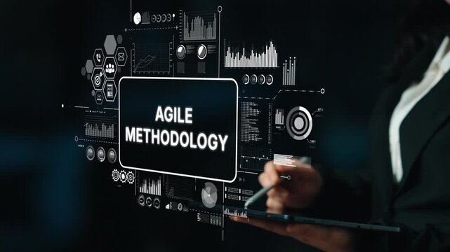 Business professional presenting concepts of Agile methodology with digital analytics and performance graphs on a dark background. Asymptotic smart data analytic.