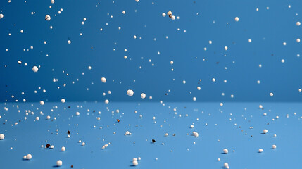 Many white spheres falling against a solid blue background. Suitable for abstract backgrounds, motion graphics, technology concepts, and modern design projects.