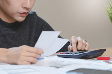 Fototapeta premium stressed young asian woman trying to find money to pay credit card debt.