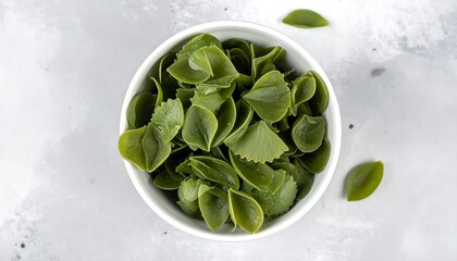 Green Spinach Pasta Shells in a White Bowl, Top View.