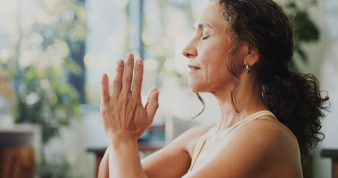 Mindfulness, yoga or woman with prayer hands in home, awareness practice or grounding exercise. Peace, meditation or mature person with holistic activity for wellness, reduce stress or spiritual zen