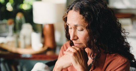 Reflection, nostalgia and senior woman in house with thoughts, past memory and sadness in living room. Mindset, space or mature person in home with perspective, wondering and sorrow in flashback.