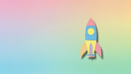 Colorful paper rocket on pastel gradient background with copy space
