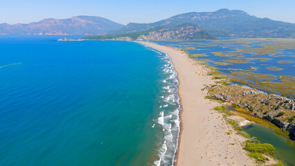Dalyan, Turkey. Panoramic drone video of Iztuzu Beach coastline, Dalyan River mouth and mountains, perfect for travel and summer holidays in Turkey.. Aerial View