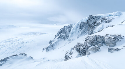 Vast snowy landscape with rocky cliffs seen under cloudy sky in a cold region during winter season