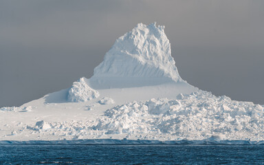 Antarctica Iceberg Shetland Islands Beautiful Ice and Snow Formation Floating in Ocean Seas. Close Up Sun Lit Frozen Landscape © And They Travel