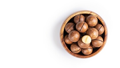 Close-up of macadamia nuts in wooden bowl, isolated on white background