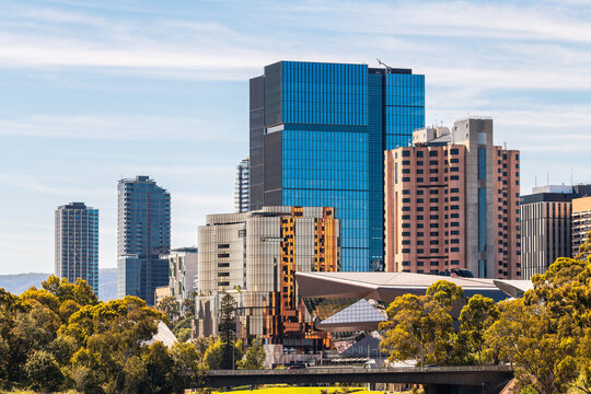 Adelaide city skyline with modern buildings viewed along the Torrens Riverbank and Montefiore Bridge on a bright, clear day in South Australia.
