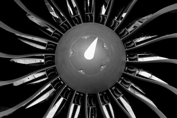 Black and white close-up of an airplane engine. Turbine and blades visible