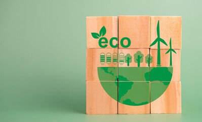 Eco-friendly concept illustration on wooden blocks with green earth and wind turbines