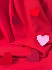 Bright, festive backdrop for birthday or Valentine's Day greetings, featuring red draped fabric and hearts symbolizing love. Can be used for gift and cosmetics promotions