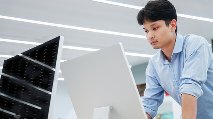A concentrated man reviewing financial statistics and global trading performance on a screen, representing expertise in banking