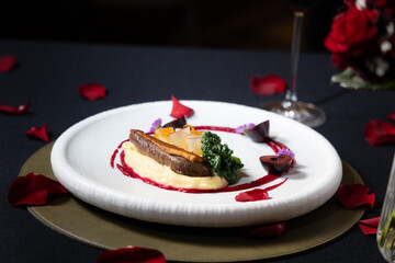 A gourmet dish on a decorative plate, decorated with rose petals, ready to eat. A culinary creation, artfully arranged and presented, inviting a sensory experience