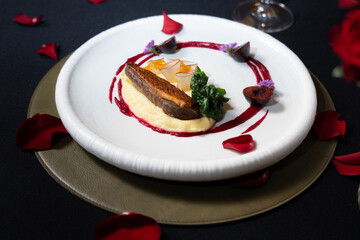 An elegant and delicious gourmet dish arranged on a white plate with artistic flair