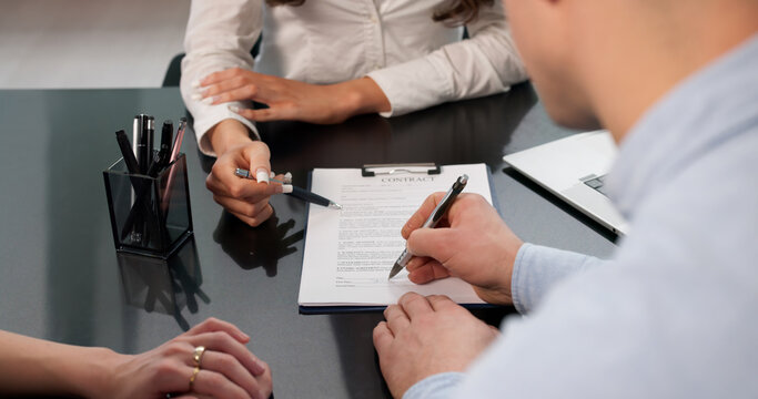 Young Couple Signing Mortgage Contract
