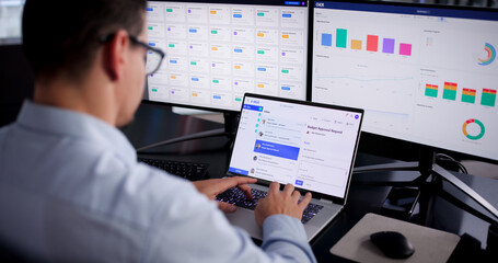 Young Hispanic Man Working On Computer, Checking Screen