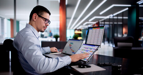 Young Hispanic Man Using Gantt Chart Software