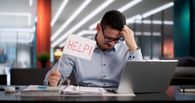 Stressed Man Holds Up Help Flag Among Piles