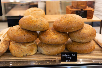 Three freshly baked loaves of multigrain cob sourdough bread