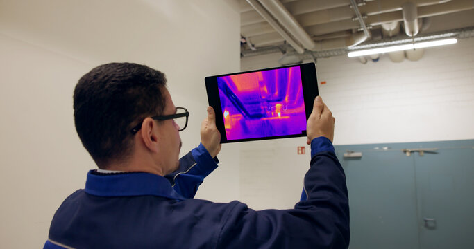 Engineer Using Thermal Camera To Check Heat Loss