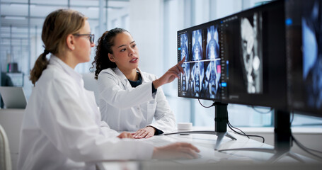 Female Radiologist Examining Spine MRI On Computer Screen