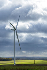 Fototapeta premium Wind turbine generating clean energy in rural France