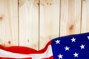 Directly above view of america flag with stars and stripes on wooden table with copy space