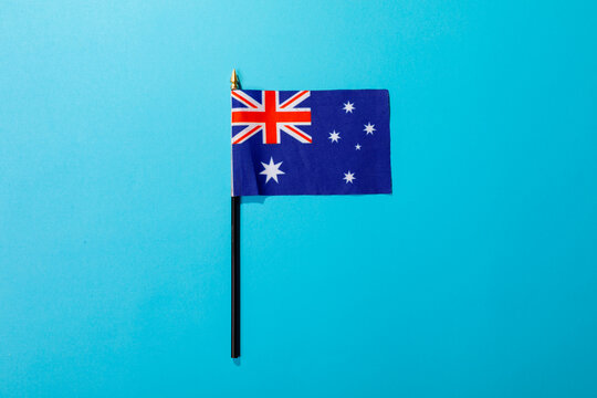 Overhead view of australia flag isolated on blue background with copy space