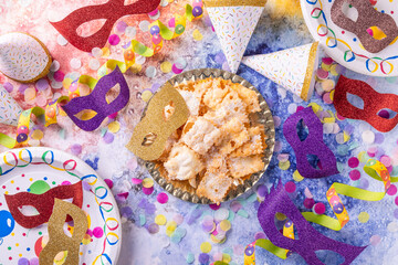 Party and carnival food with masks, confetti and streamers